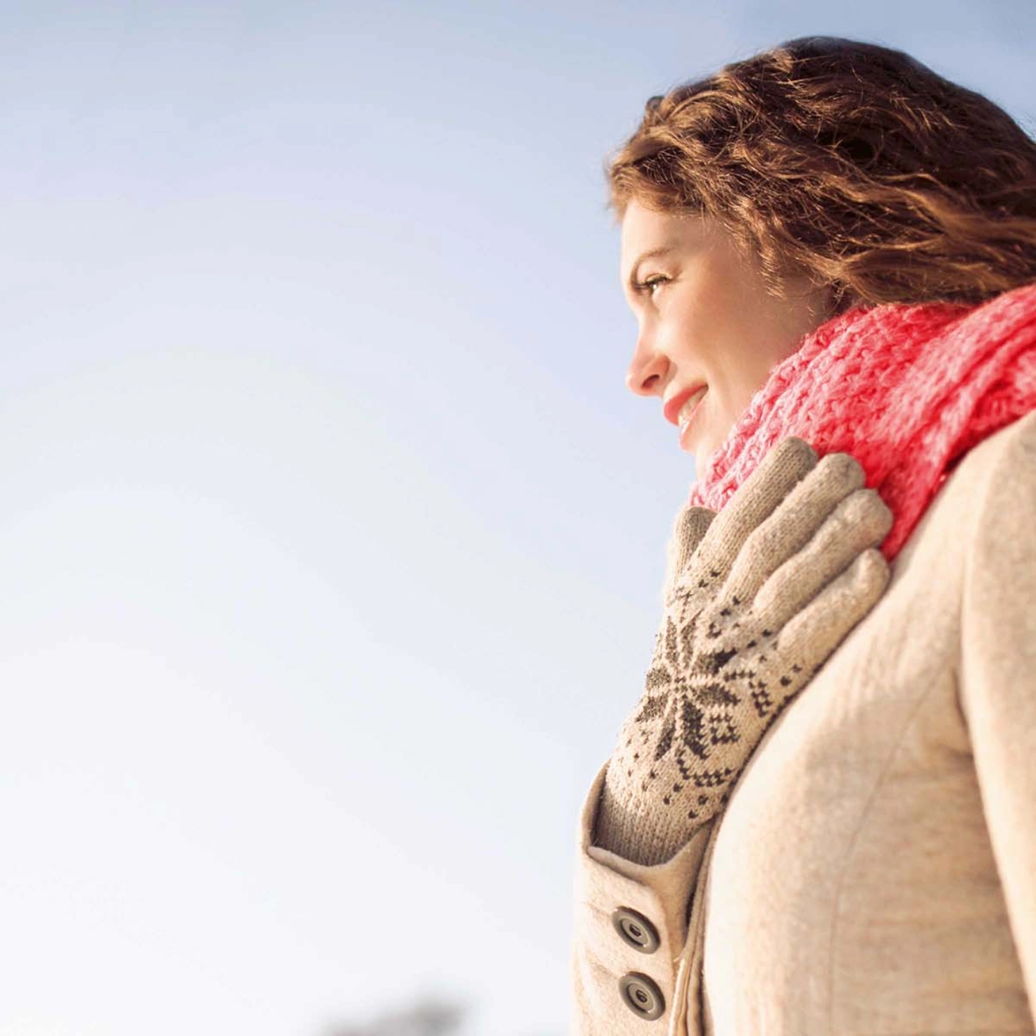 A woman with a scarf stands in a winter landscape