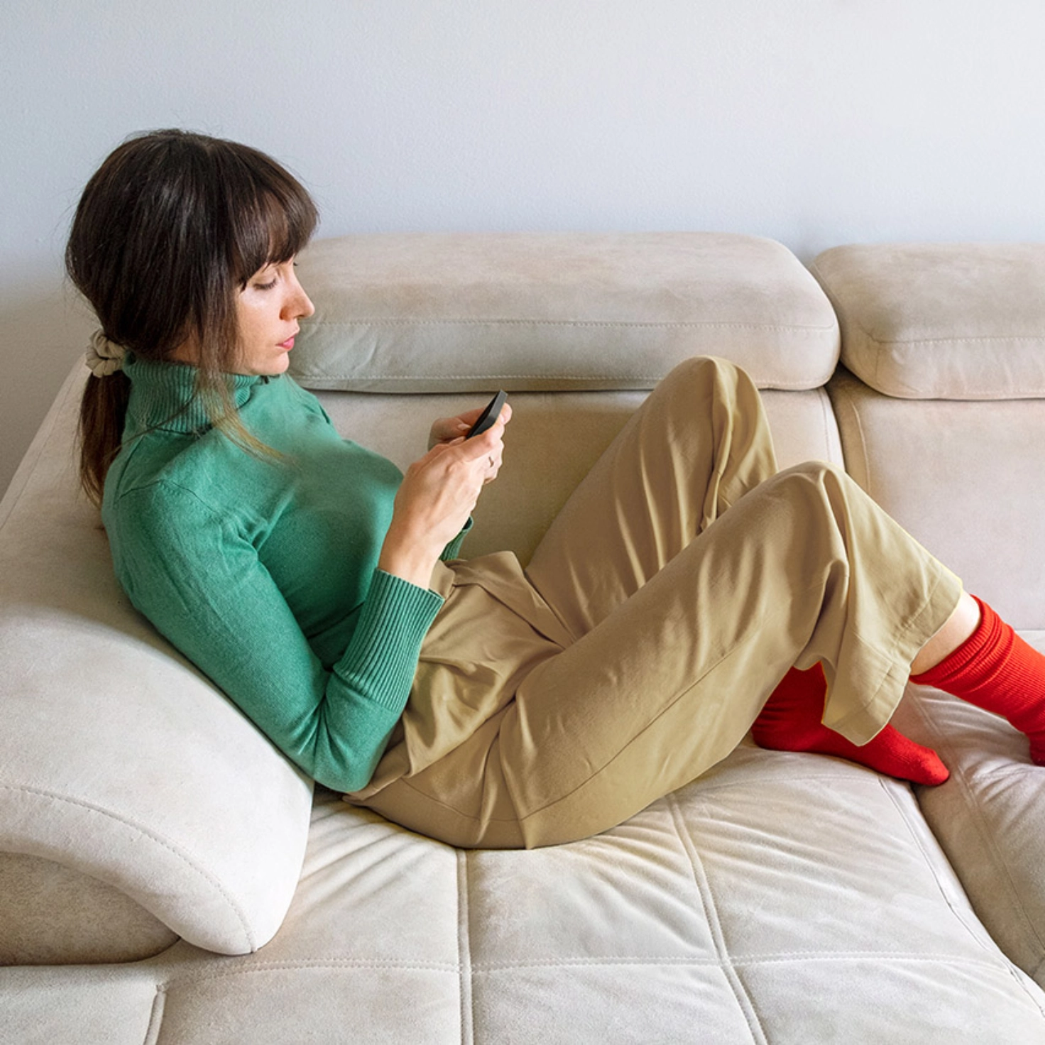 A woman watches a man photographing a document with a smartphone.