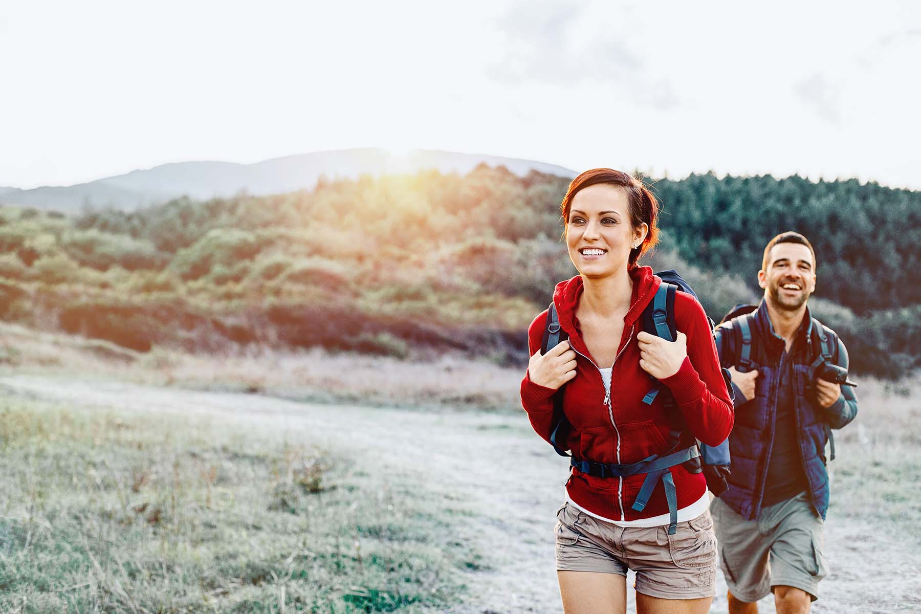 Woman and man hiking in autumn